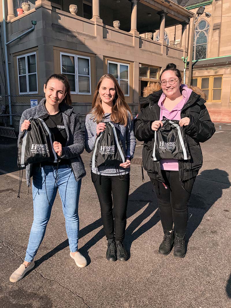 Three ladies standing carrying hankeylaw bags